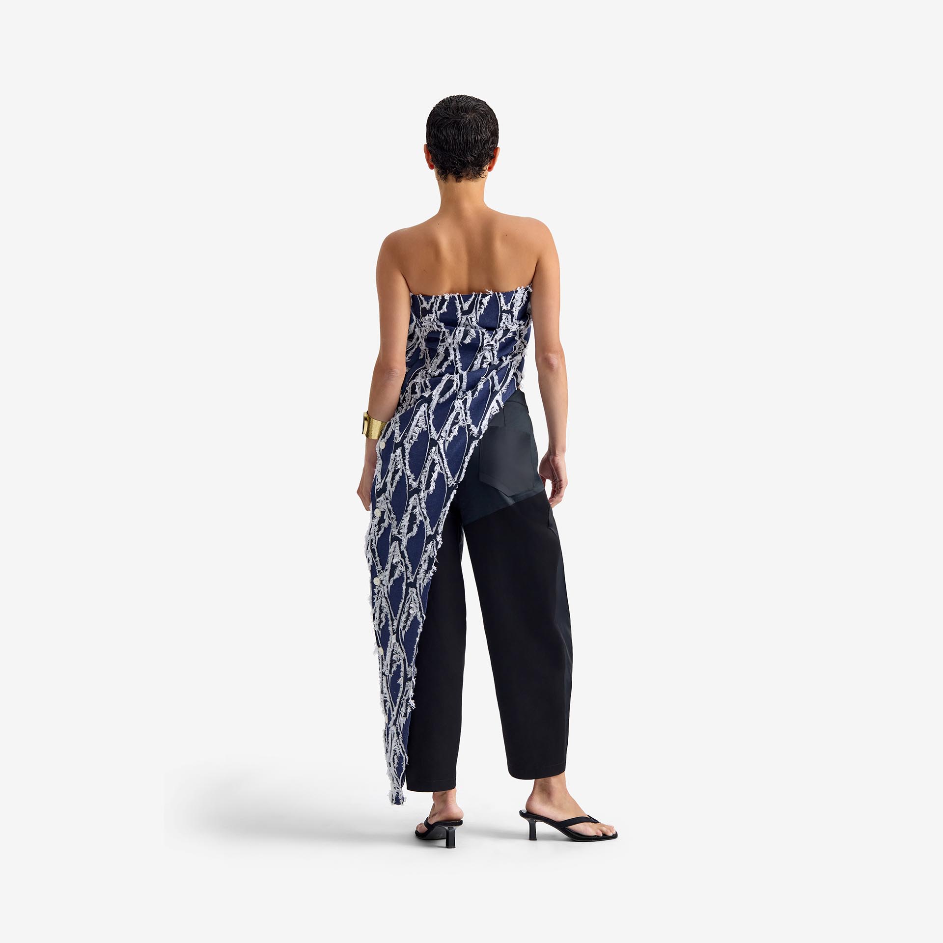 Silk Nest Top Mixed Pattern Denim - This bandeau top showcases a sleek, straight neckline and an asymmetrical silhouette, highlighted by one elongated side with decorative buttons for visual impact.